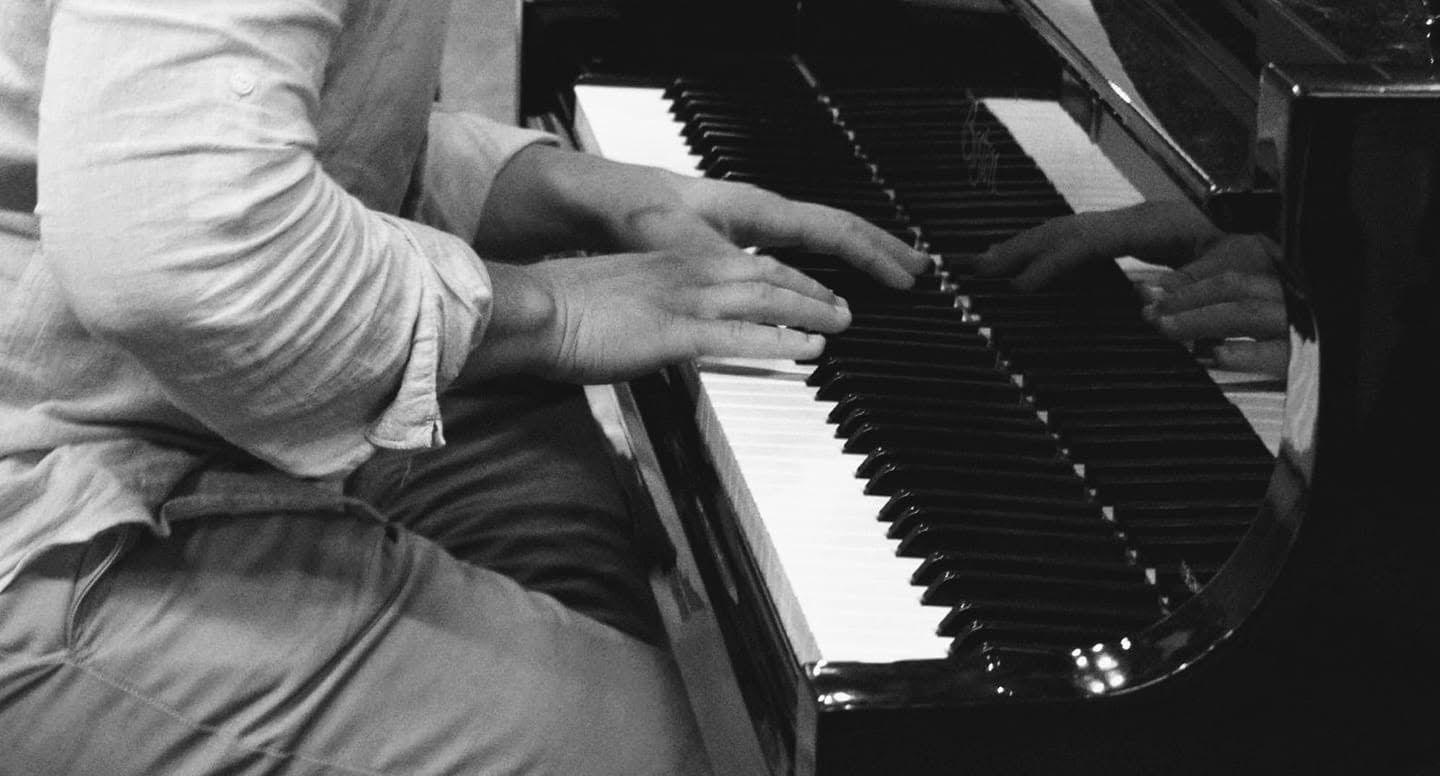 Zacharias Yeranis playing piano in black and white